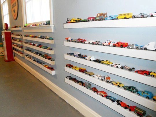 Cars on a picture ledge to display collections on playroom walls