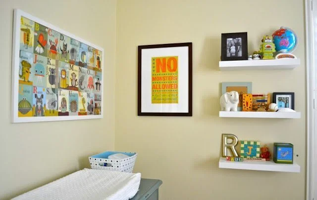 Baby change table corner of the nursery - there are some floating shelves and wall art
