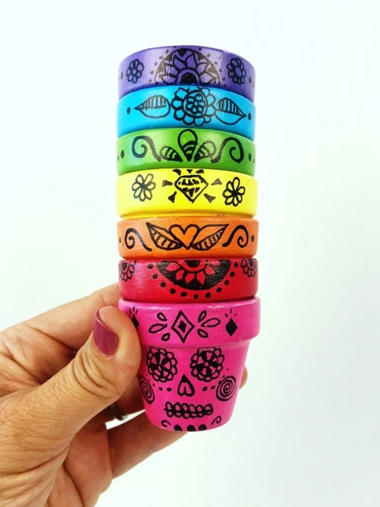 stack of colorful painted Sugar Skull Flower Pots