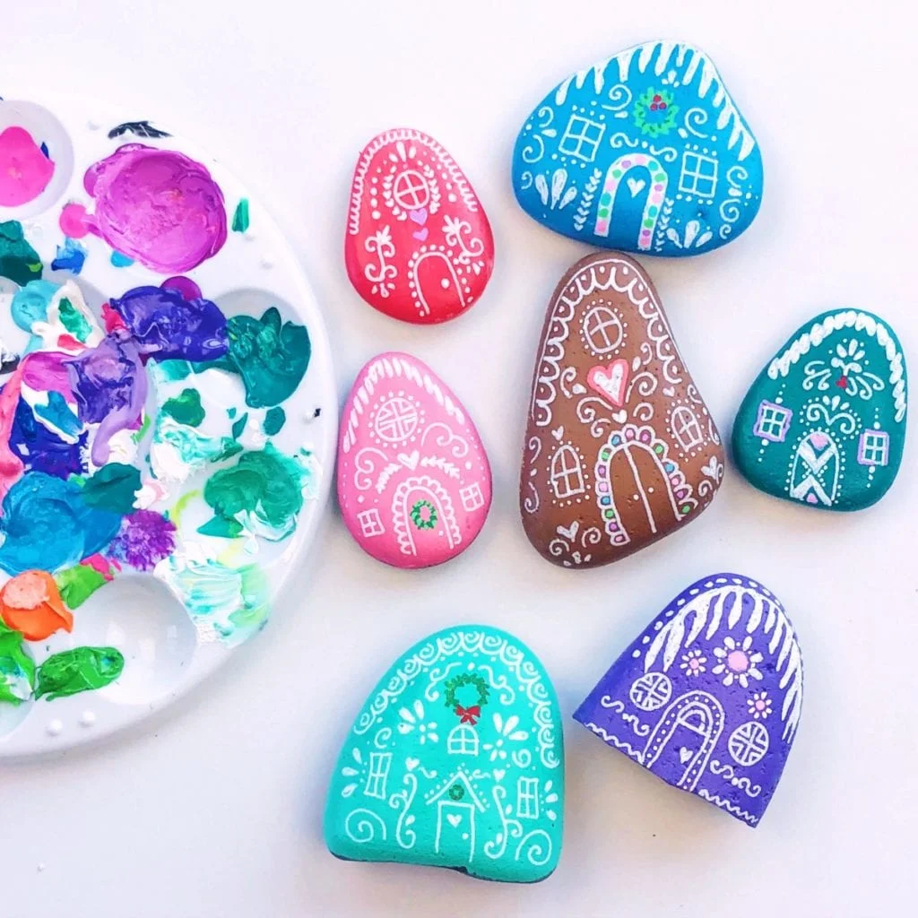 Painted Rock Gingerbread Houses next to a paint palette 