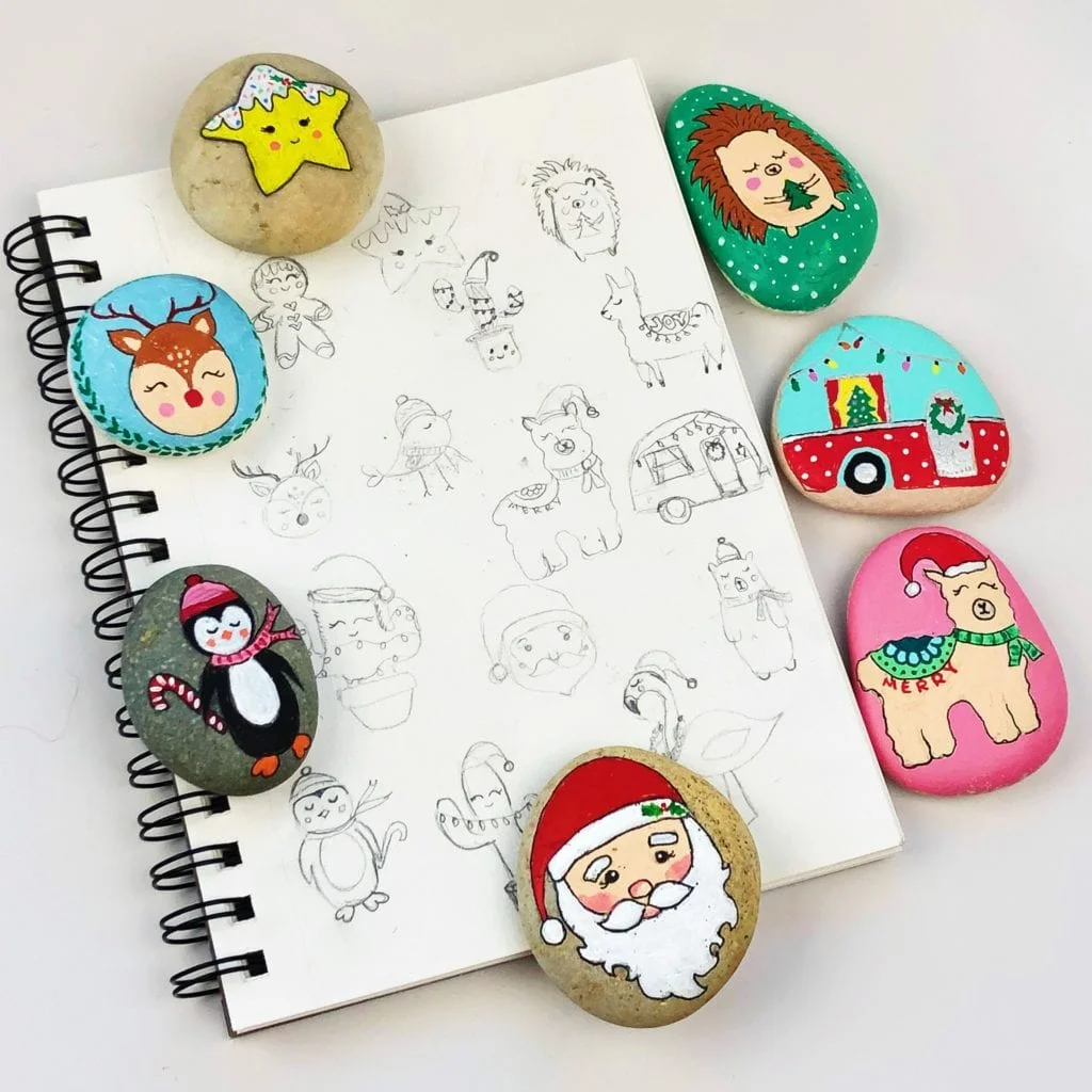 Sketch book showing different painted rock design ideas that were eventually used in the final crafts