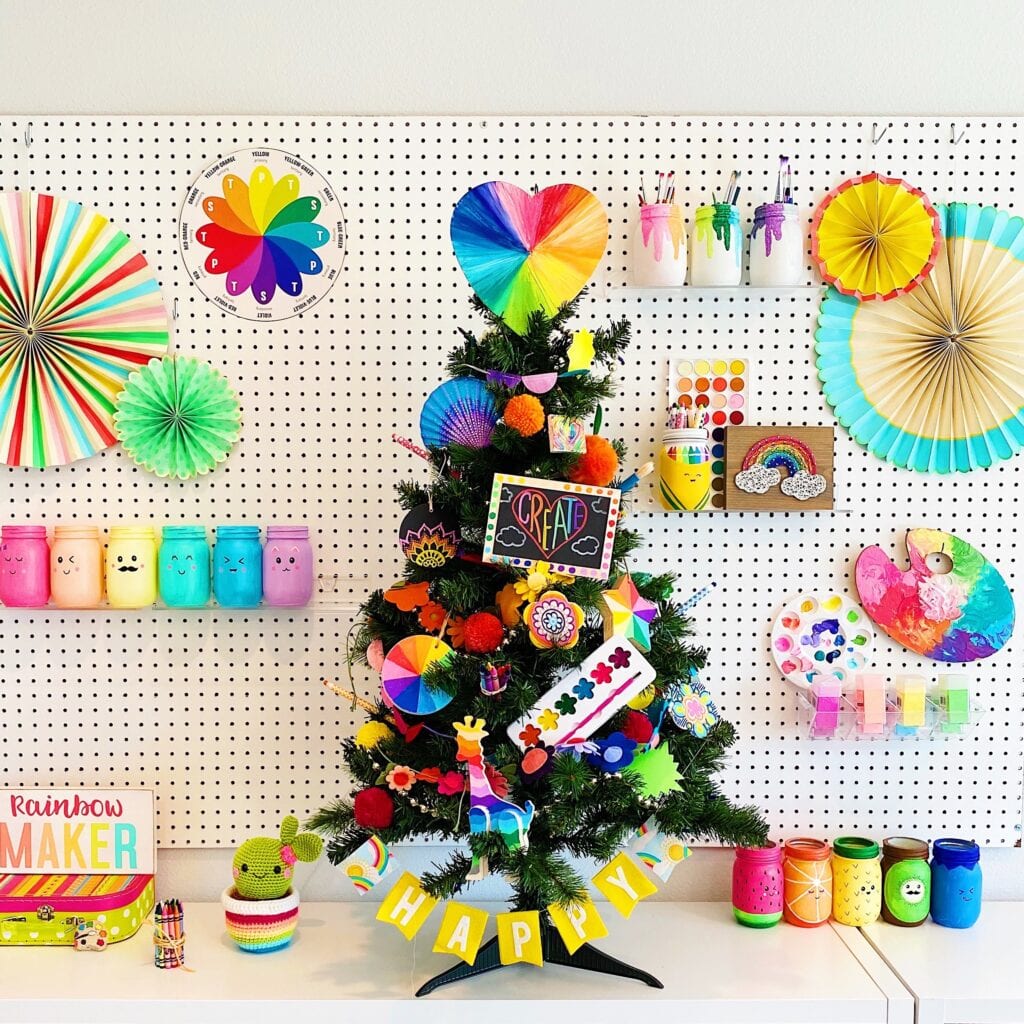 Art Christmas Tree - the mini Christmas tree is decorated with art themed items like craft supplies, homemade ornaments, and a color wheel