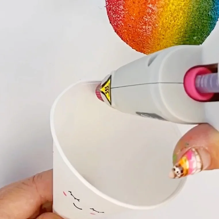Applying hot glue to the cone