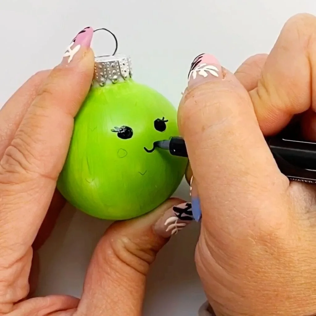 Drawing the face on the cute cactus