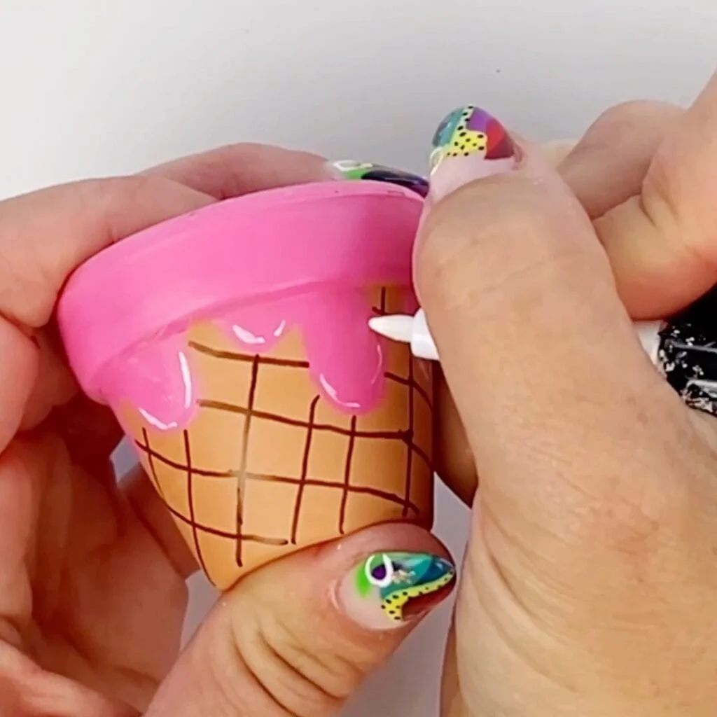 Adding details to our mini painted flower pot to create a cute ice cream cone design