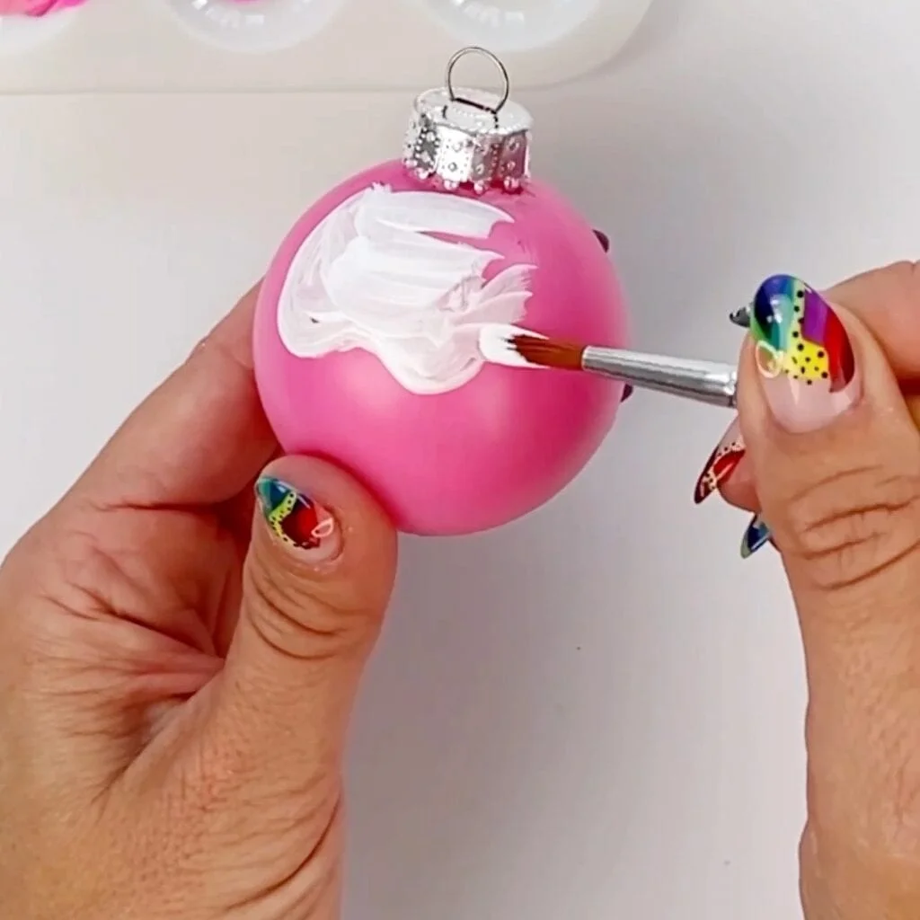 Painting the white topping onto the Christmas ornament