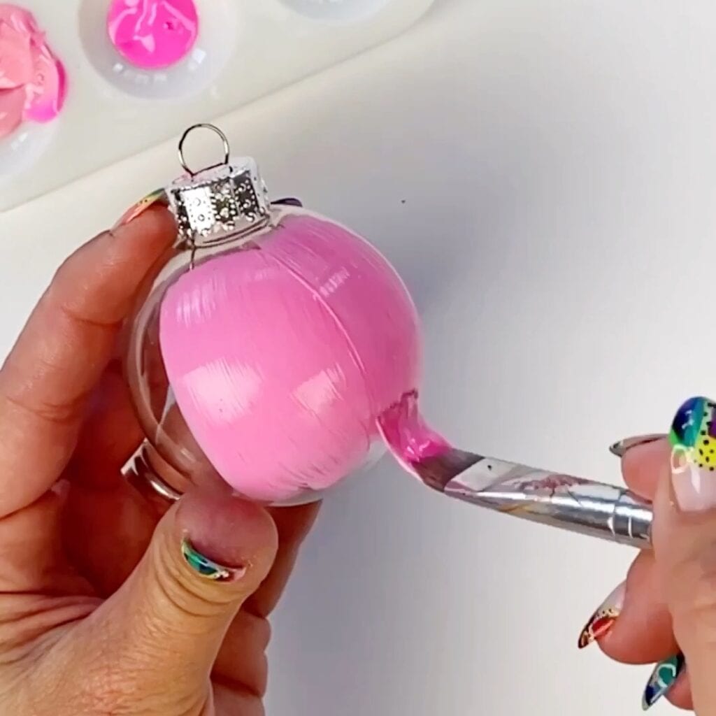 Painting a Christmas ornament pink with acrylic paint - this will be the scoop of ice cream