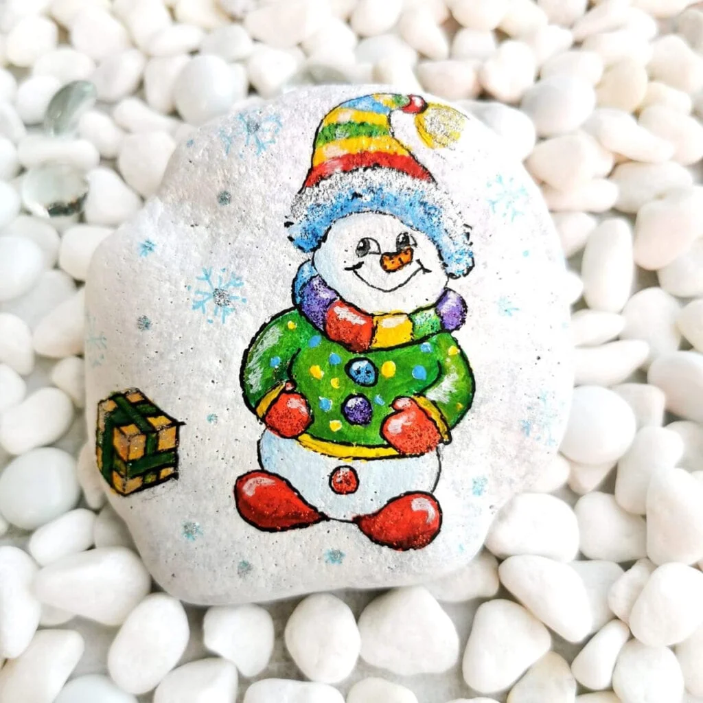 How to paint a colorful snowman on a rock