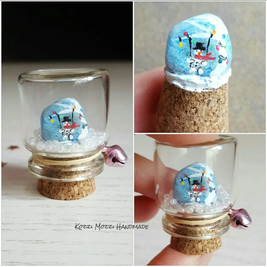Snowman painted rock snow globe