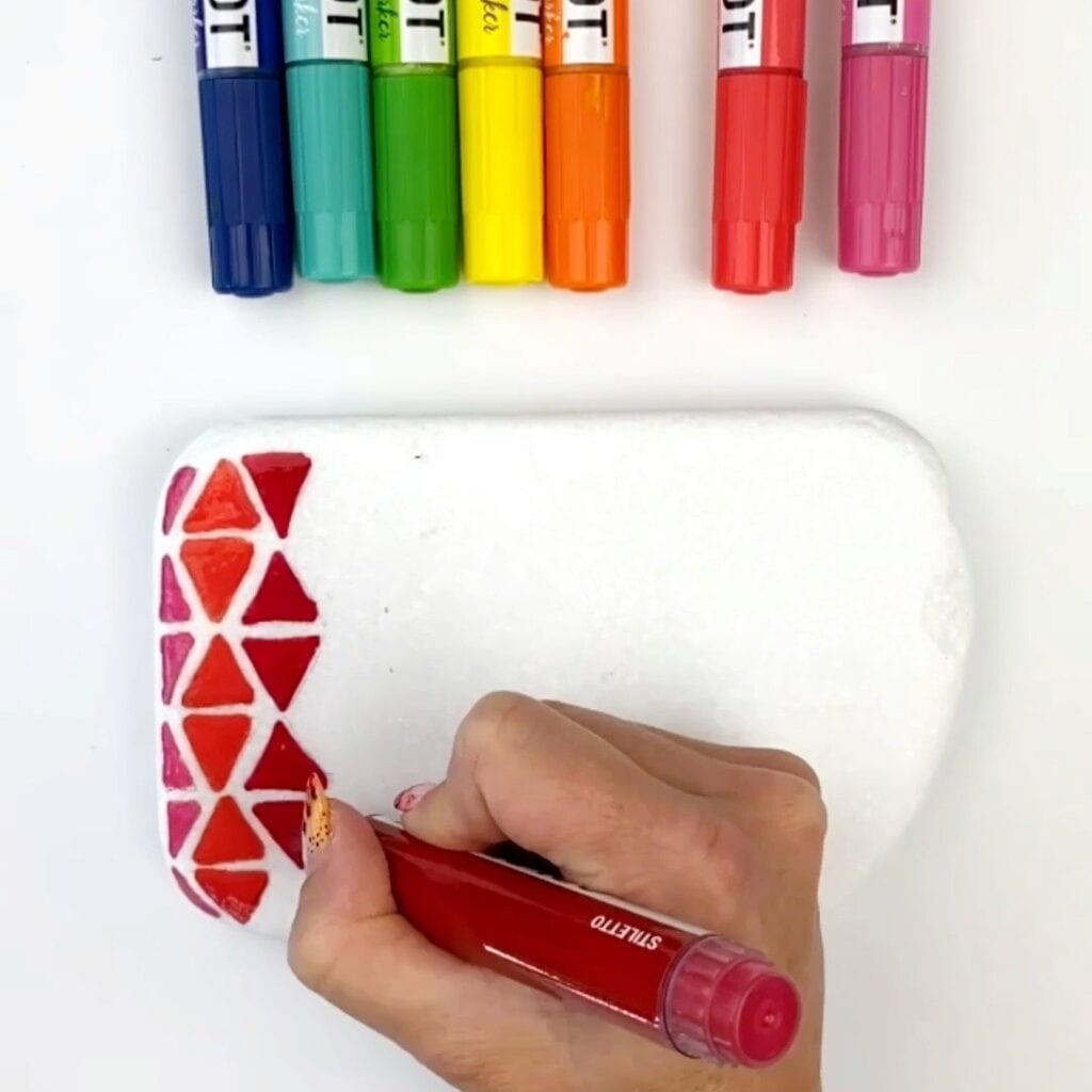 Drawing the triangles in with paint markers