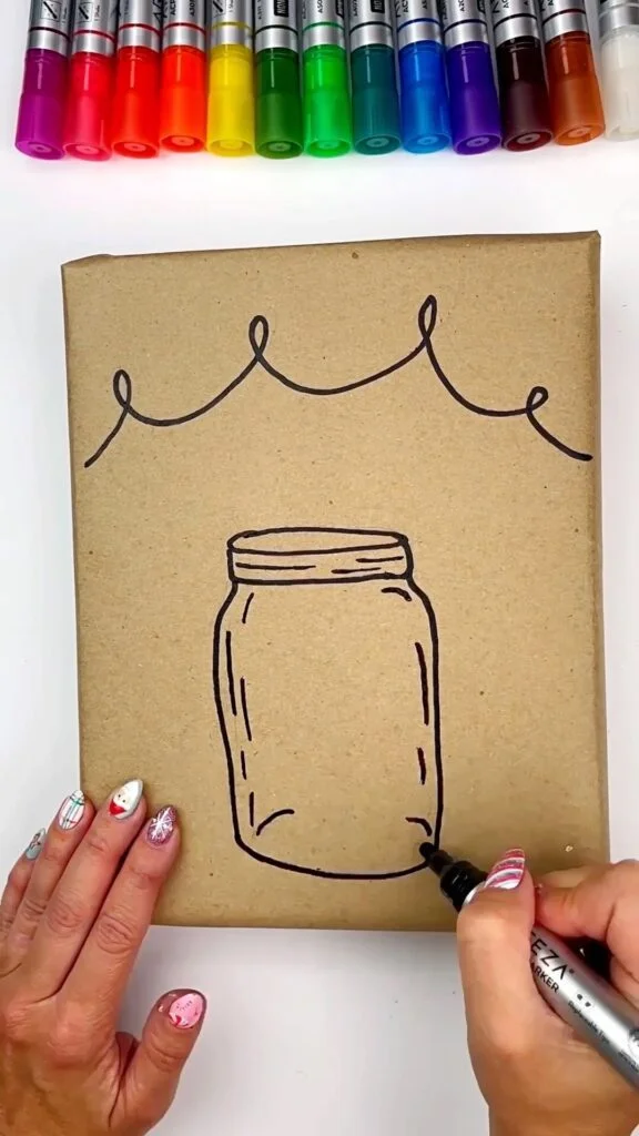 Wrapping paper DIY drawing the outline of the mason jar and lights with black marker