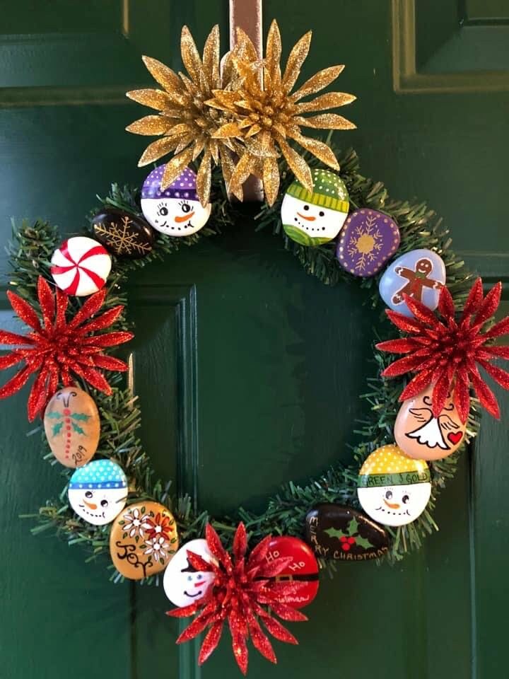 Painted Rock Ideas - How to Make a Painted Rock Wreath finished product of a painted rock Christmas wreath hanging on the door