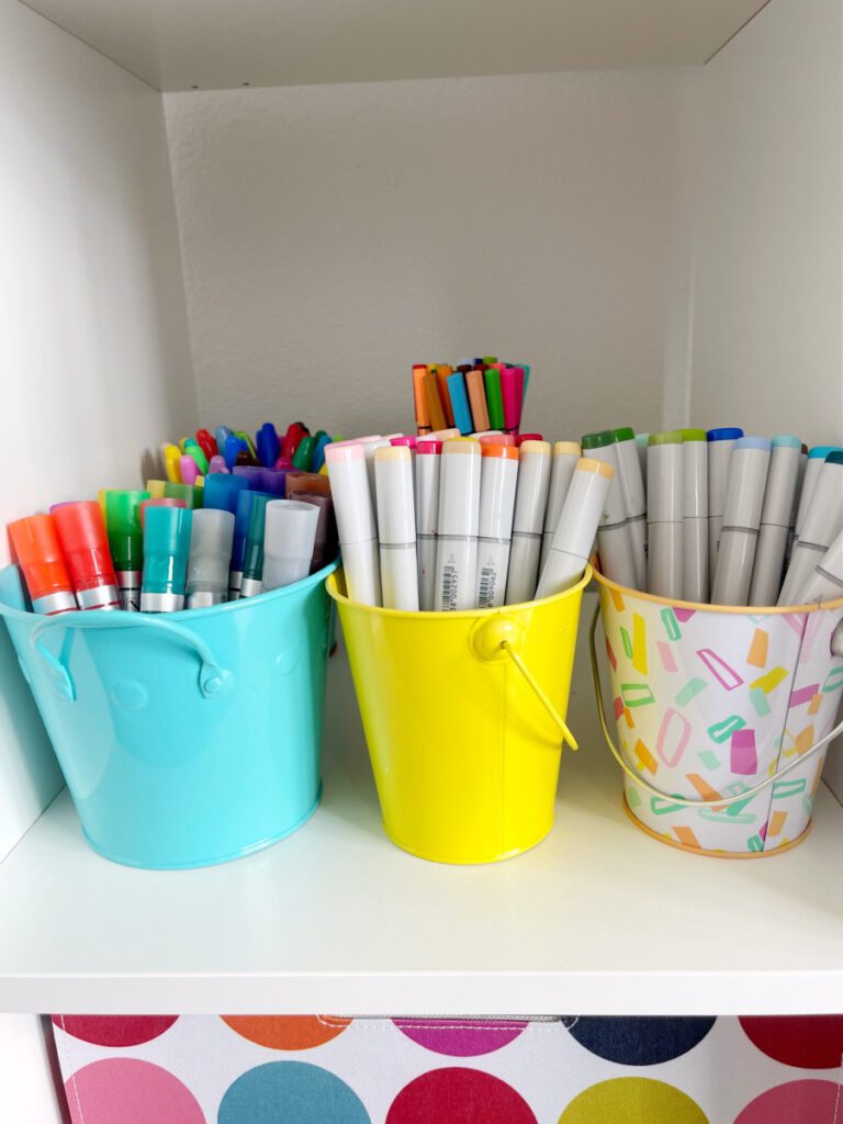 Using metal pails to organize pens in a crafting space