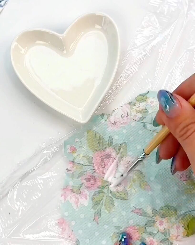 Decoupaging a heart ring dish with napkins
