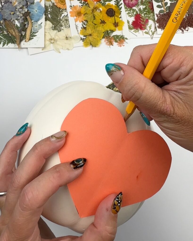 Trace heart onto pumpkin