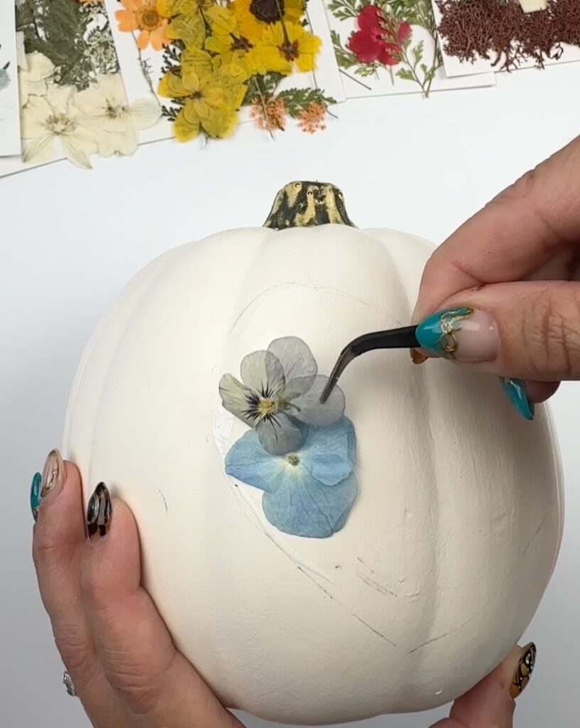 Add pressed flowers and layer slightly 